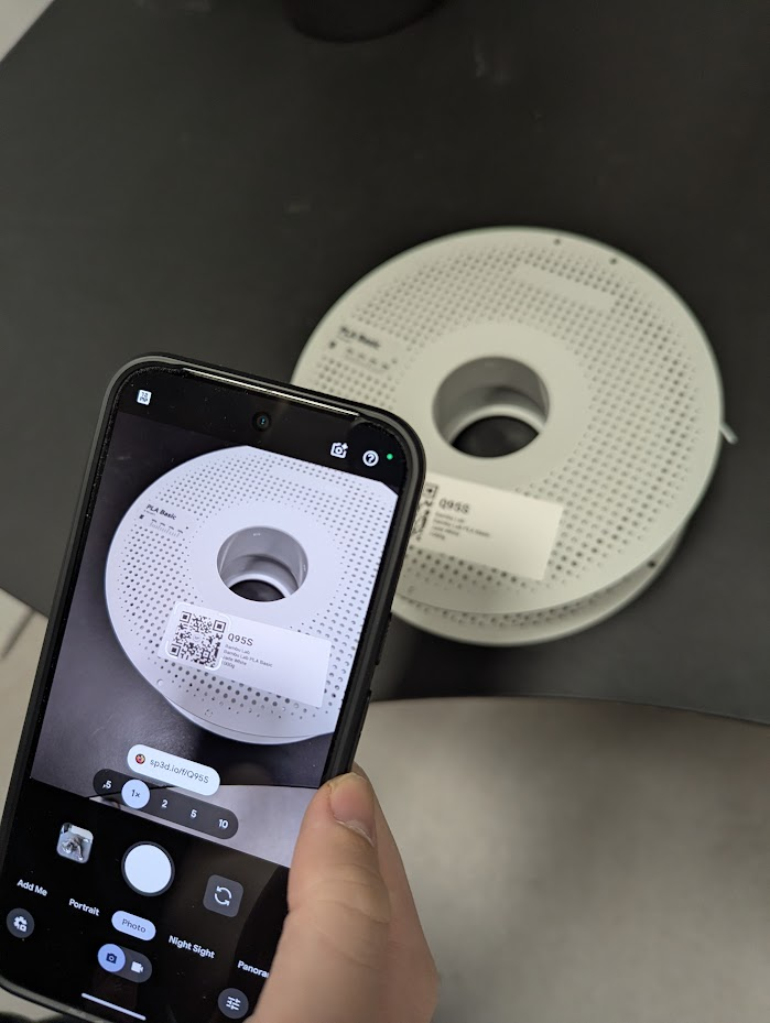 Phone camera scanning a SimplyPrint QR code